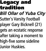 Legacy and tradition Bill Ollar of Yuba City Sutter's Varsity Football player Gary Bicknell (21) gets an ecstatic res...