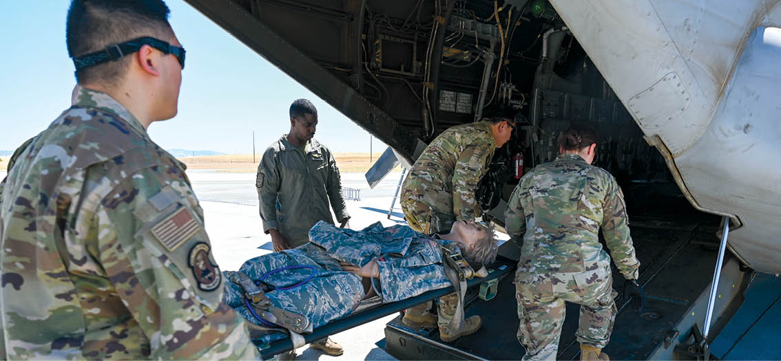 U.S. Airmen from the 349th Medical Squadron from Travis Air Force Base train loading and unloading a patient onto a U.S. Marine Corps MV-22 Osprey on Beale Air Force Base, California, July 29, 2025. The Travis medical team partnered with the Marine Medium Tiltrotor Squadron 163 to conduct the training while the Marine unit was conducting a Marine Corps Combat Readiness Evaluation in preparation for a deployment. (U.S. Air Force photo by Senior Airman Alexis Pentzer)